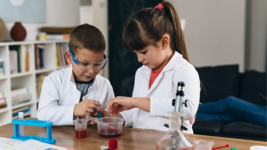 Dzieci bawią się w pokoju zestawem małego chemika.